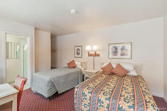 a bedroom with double bed and a lamp