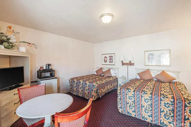 a bedroom with bed a lamp and a window