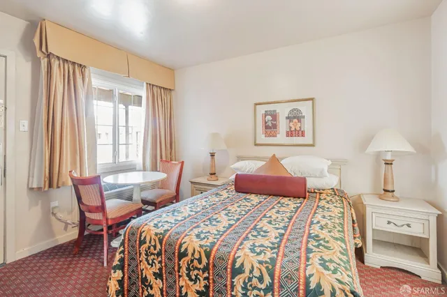 a bedroom with furniture and a flat screen tv