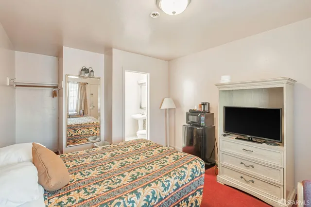 a bathroom with a sink mirror and toilet