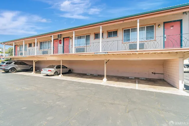 a view of a house with wooden fence