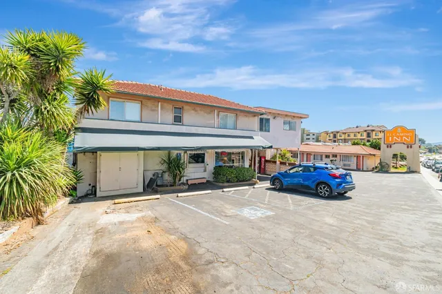 a balcony with wooden floor and city view
