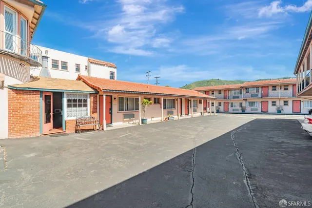 a front view of a residential apartment building with a yard