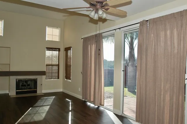 a view of a livingroom with a fireplace and windows