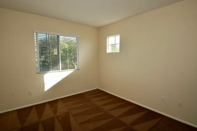 a view of a room with wooden floor and a bathroom