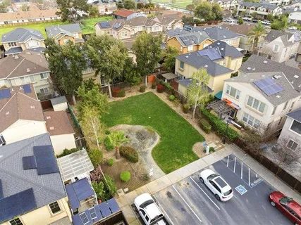 an aerial view of a residential houses with outdoor space