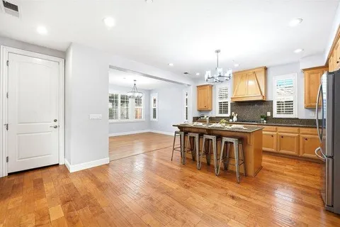a kitchen with granite countertop a stove top oven a sink a counter space and cabinets