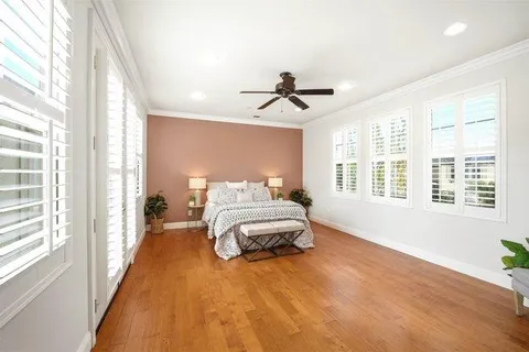 a spacious bedroom with a large bed and a large window
