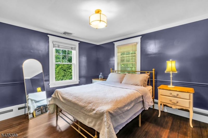 105 Somerville Road Bedminster, NJ 07921 - Photo 15 of 36 a bedroom with a bed and a chandelier