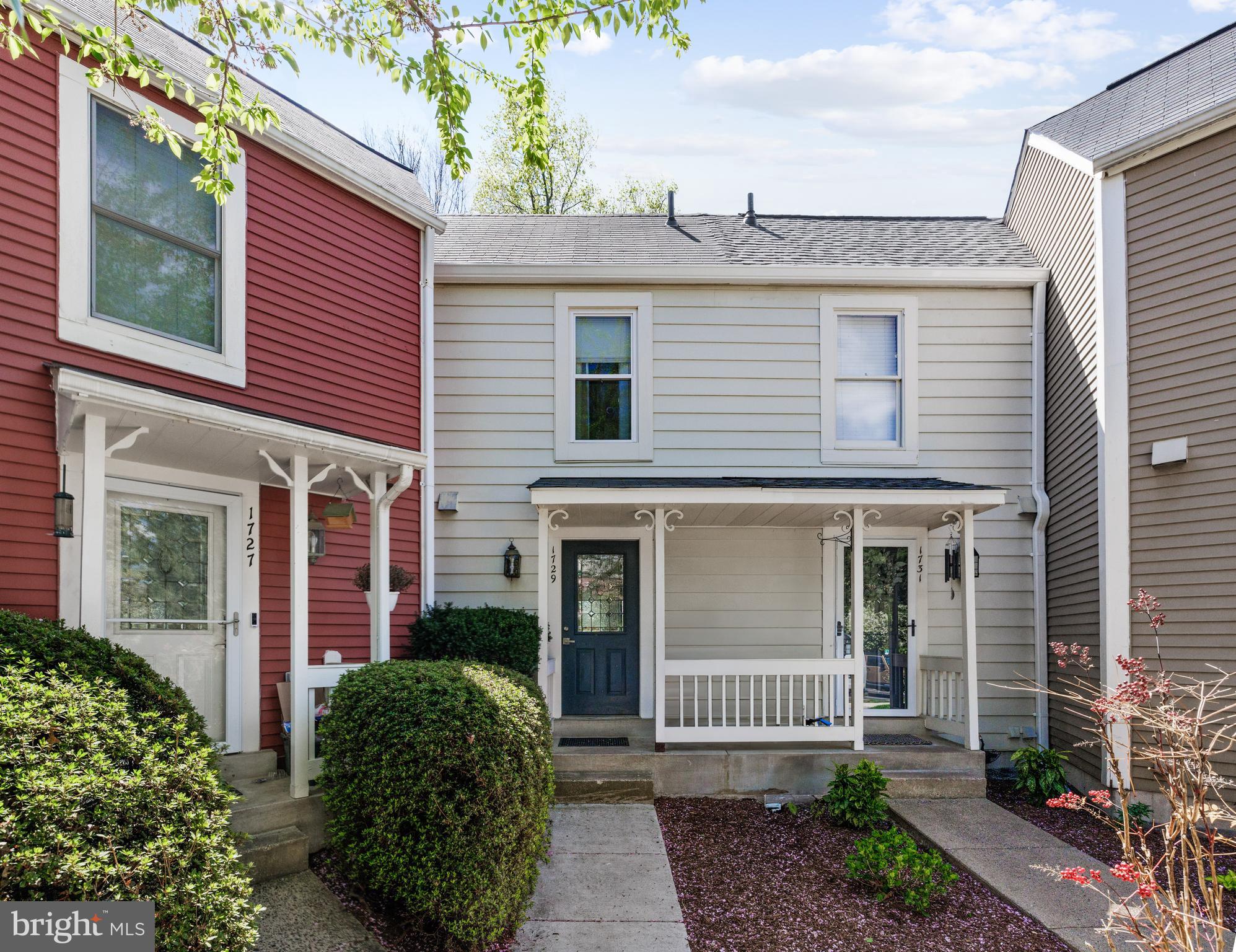 1729 Quietree Drive Reston, VA 20194 - Photo 13 of 22 a front view of a house with a garden