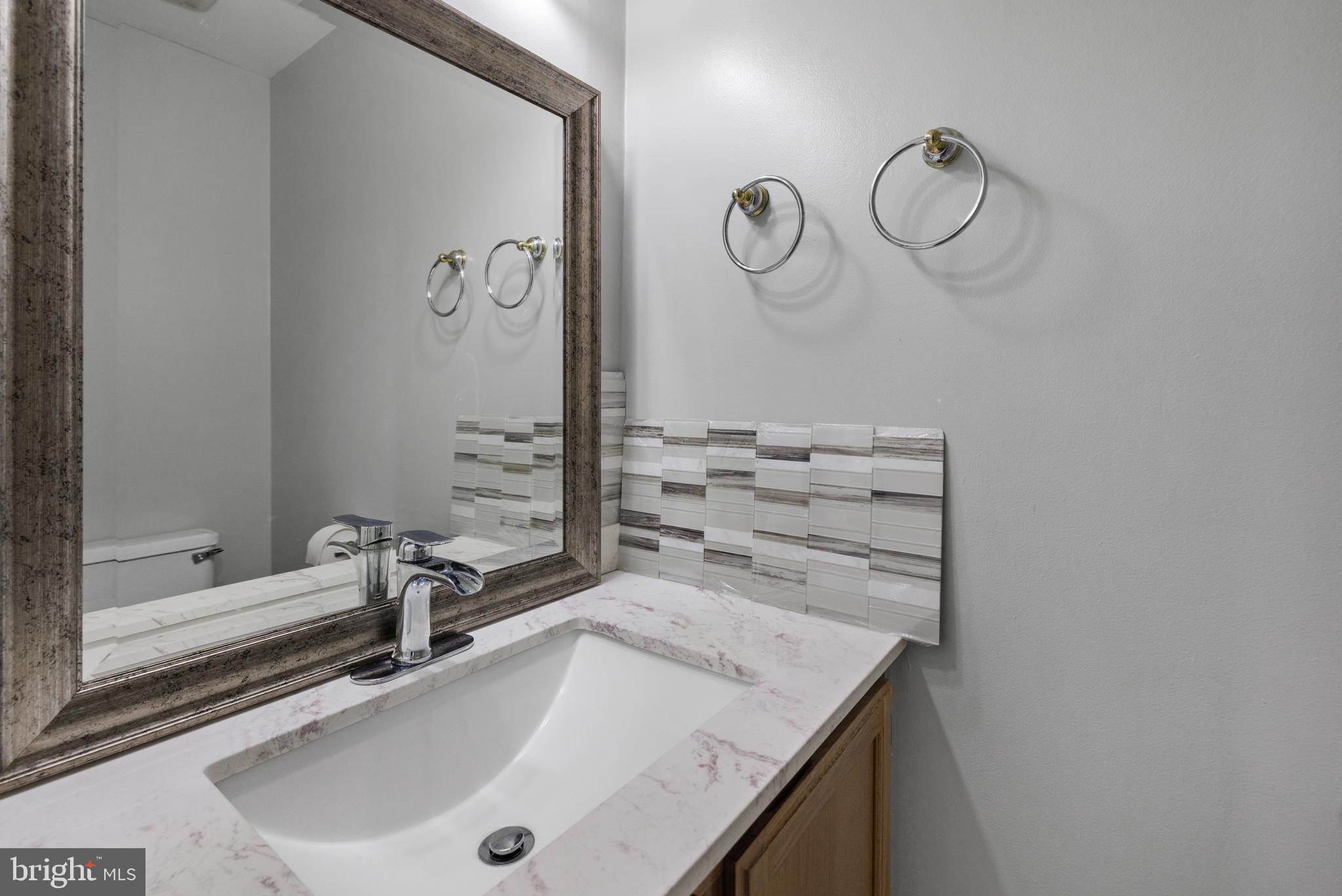 1729 Quietree Drive Reston, VA 20194 - Photo 14 of 22 a bathroom with a sink and a mirror