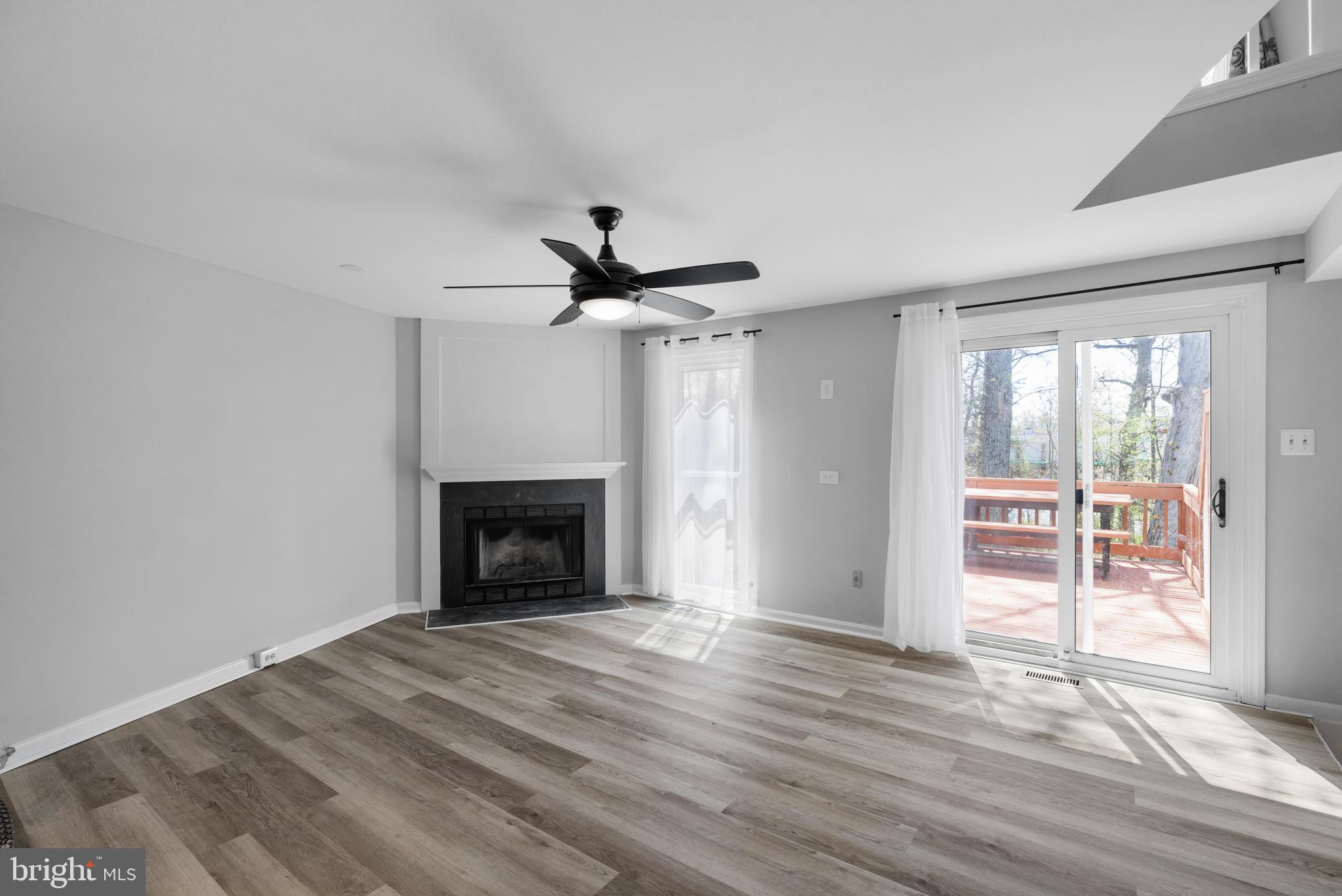 1729 Quietree Drive Reston, VA 20194 - Photo 3 of 22 a view of empty room with wooden floor and fireplace