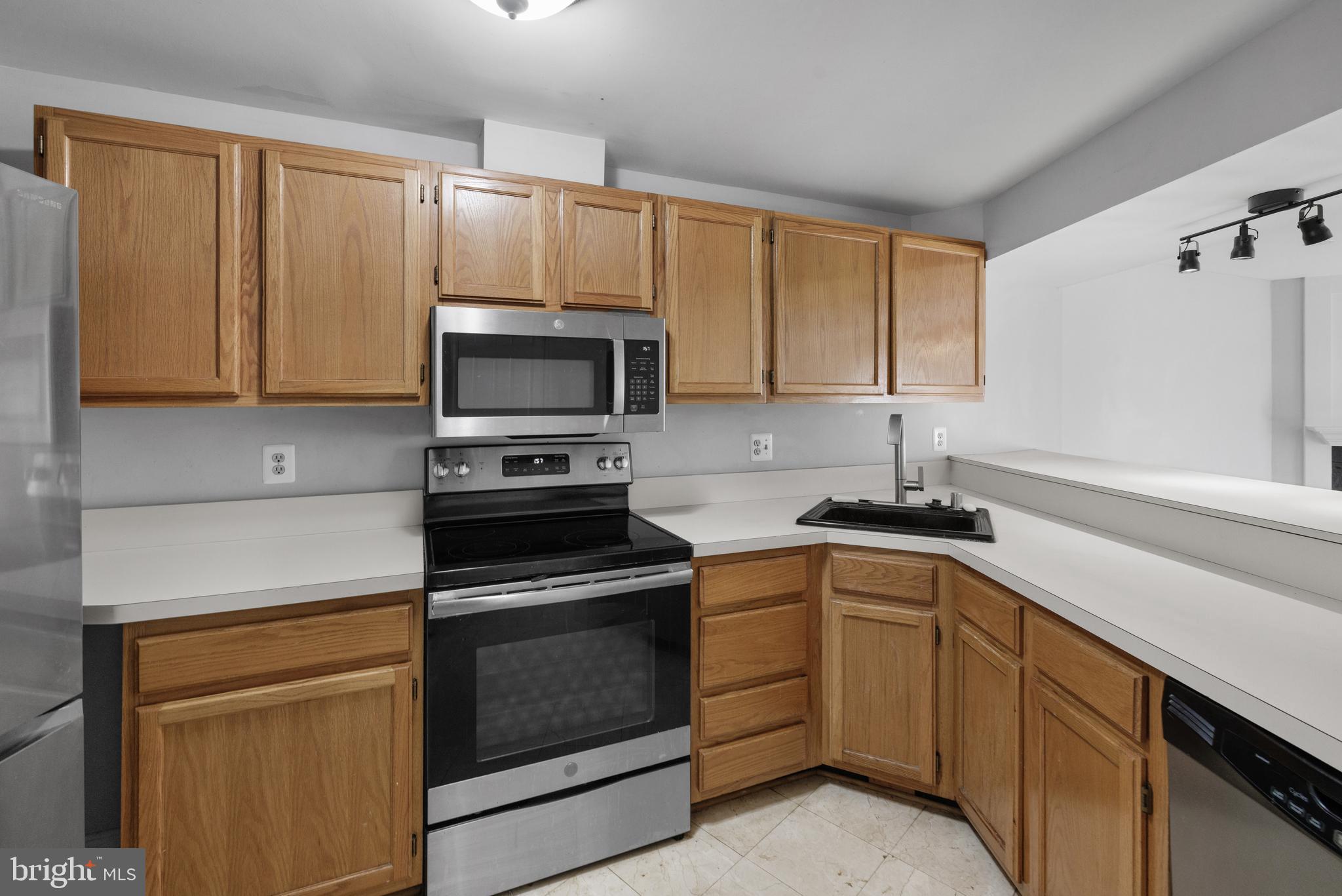 1729 Quietree Drive Reston, VA 20194 - Photo 5 of 22 a kitchen with cabinets appliances and a window