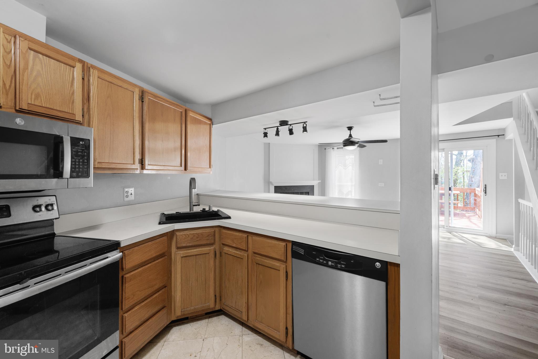 1729 Quietree Drive Reston, VA 20194 - Photo 6 of 22 a kitchen with granite countertop a sink stainless steel appliances and cabinets