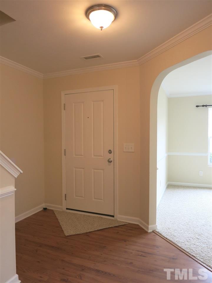 6714 Harter Court Raleigh, NC 27610 - Photo 2 of 25 Welcoming Foyer w/laminate flooring & crown molding. NEW neutral carpet & paint throughout home! Spacious formal Living Rm/Study w/neutral carpet & crown/chair rail molding is nearby.