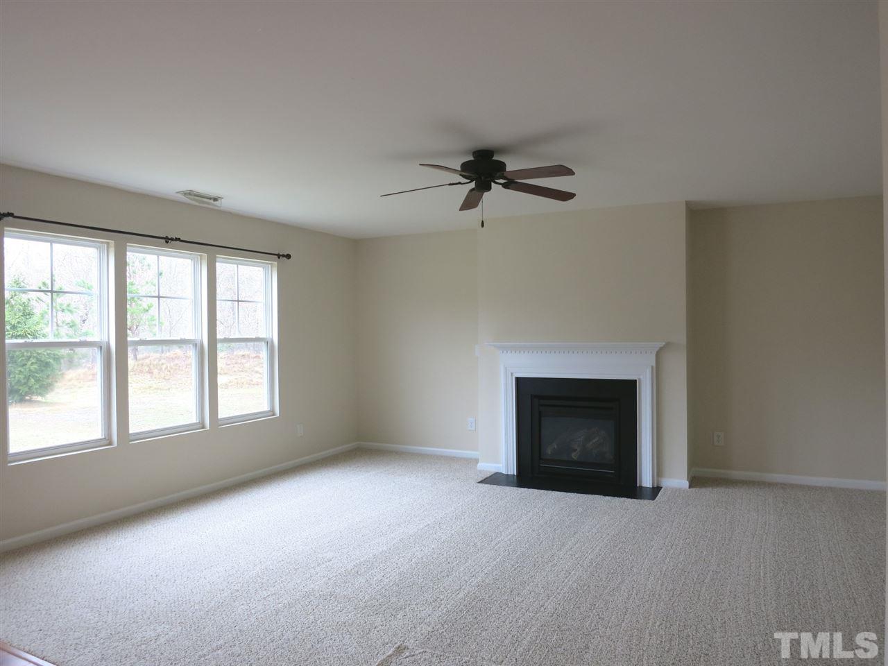 6714 Harter Court Raleigh, NC 27610 - Photo 11 of 25 Lg Family Rm w/neutral carpet, CF, gas log FP w/slate surround & wood mantle.