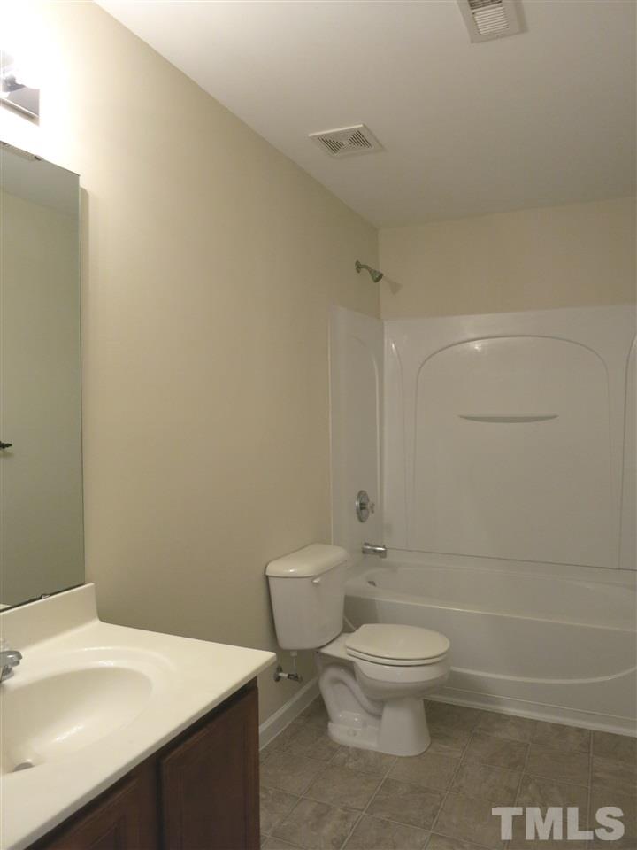 6714 Harter Court Raleigh, NC 27610 - Photo 15 of 25 View of the spacious Hall Bath w/stone-look vinyl flr & tub/shower.