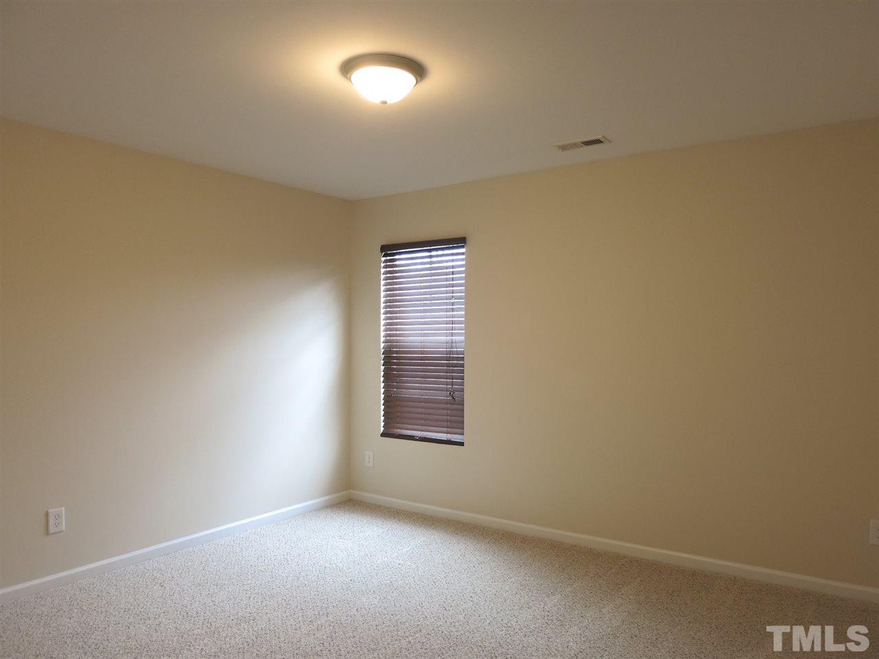 6714 Harter Court Raleigh, NC 27610 - Photo 16 of 25 Bedroom 2 has neutral carpet & lg closet.