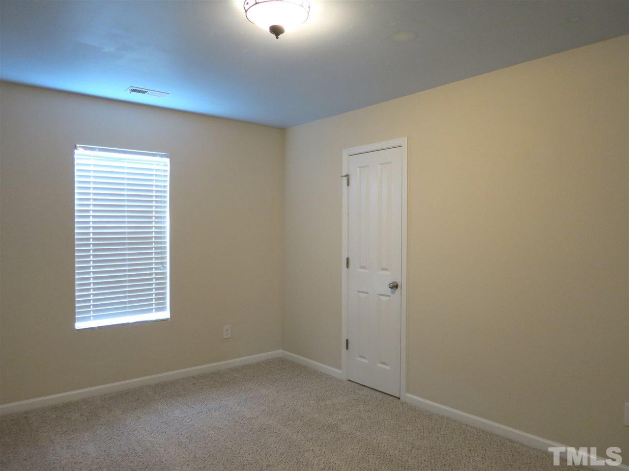 6714 Harter Court Raleigh, NC 27610 - Photo 18 of 25 Bedroom 4 has neutral carpet & lg WIC w/window.