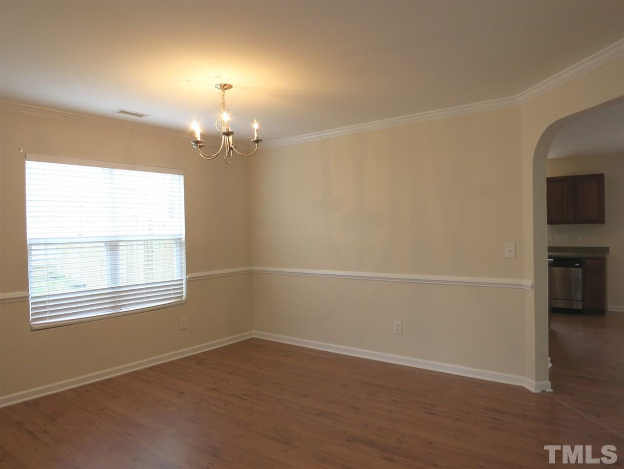 6714 Harter Court Raleigh, NC 27610 - Photo 3 of 25 The formal Dining Rm w/laminate flr, brushed nickel chandelier & crown/chair rail molding is off the welcoming Foyer.