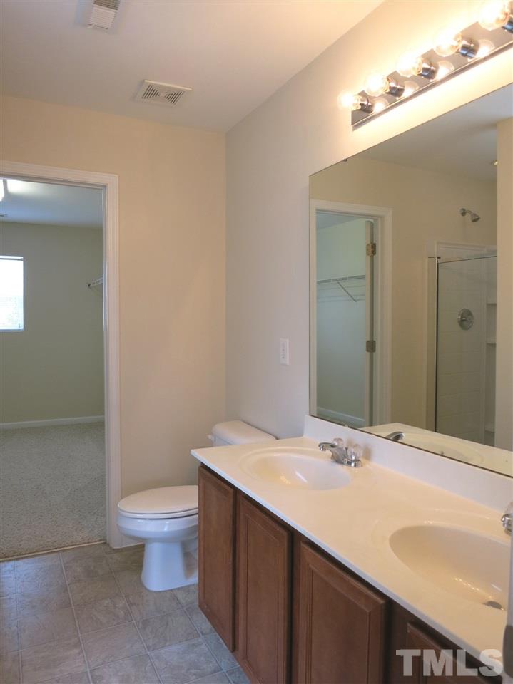 6714 Harter Court Raleigh, NC 27610 - Photo 21 of 25 The Master Bath offers double sinks, garden tub, separate shower & stone-look vinyl flr.