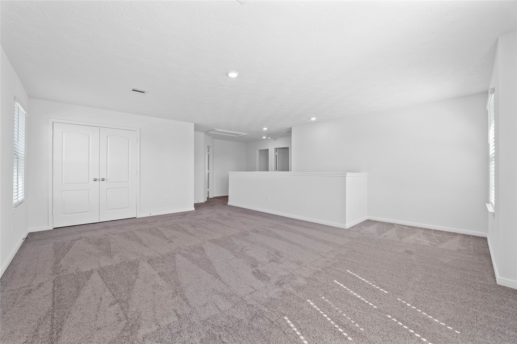 3519 Rocky Aspen Dr Spring Spring, TX 77373 - Photo 14 of 29 Another perspective of the Loft, showcasing the staircase, linen closet, and hallway leading to the secondary bedrooms.