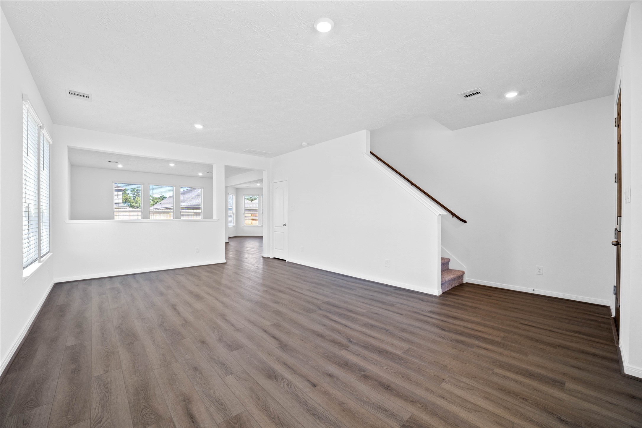 3519 Rocky Aspen Dr Spring Spring, TX 77373 - Photo 4 of 29 Upon entering you find a lovely formal living and dining space showcasing neutral paint, beautiful vinyl plank flooring, high ceilings, recessed lighting, windows with privacy blinds, coat closet, and staircase leading to the second floor!