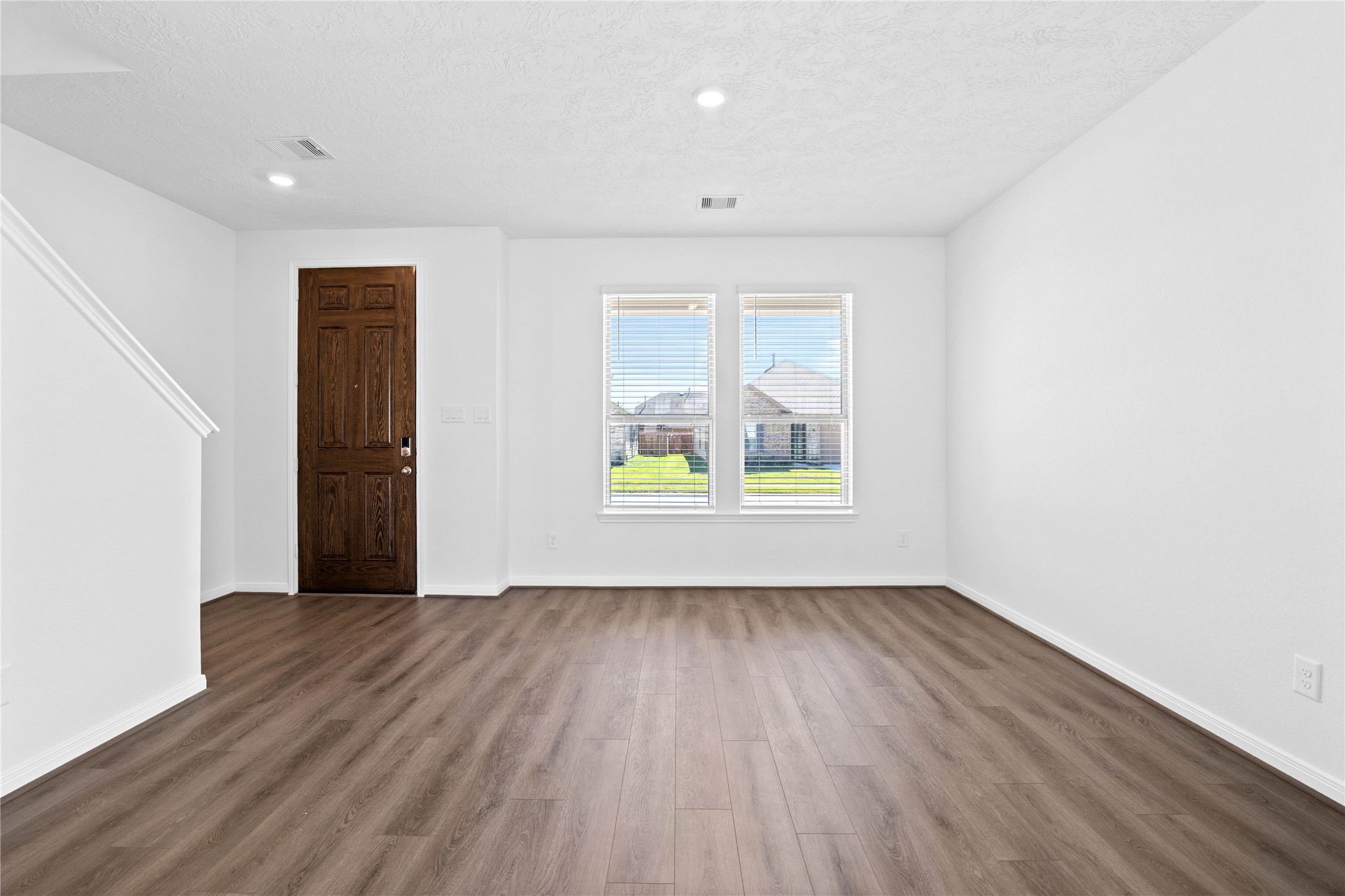 3519 Rocky Aspen Dr Spring Spring, TX 77373 - Photo 5 of 29 The formal living room offers a polished, elegant space designed for entertaining guests and special occasions. Featuring the gorgeous Layton Lake vinyl plank flooring in Ashen Brown, neutral paint, high ceilings, recessed lighting, and large windows with privacy blinds.