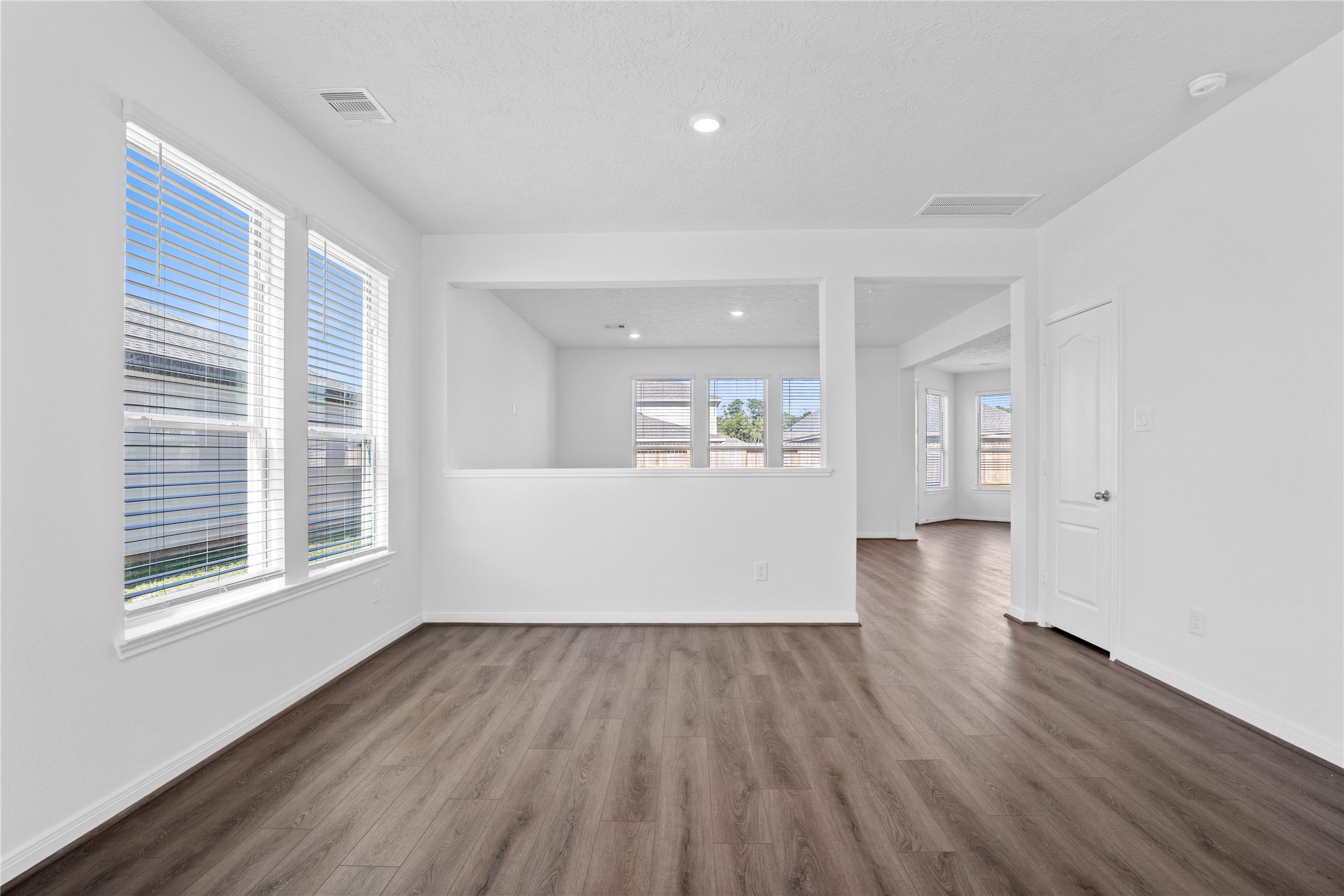 3519 Rocky Aspen Dr Spring Spring, TX 77373 - Photo 6 of 29 Create lasting memories with family and friends in this inviting dining room! It showcases high ceilings, recessed lighting, neutral paint, and stunning vinyl plank flooring.