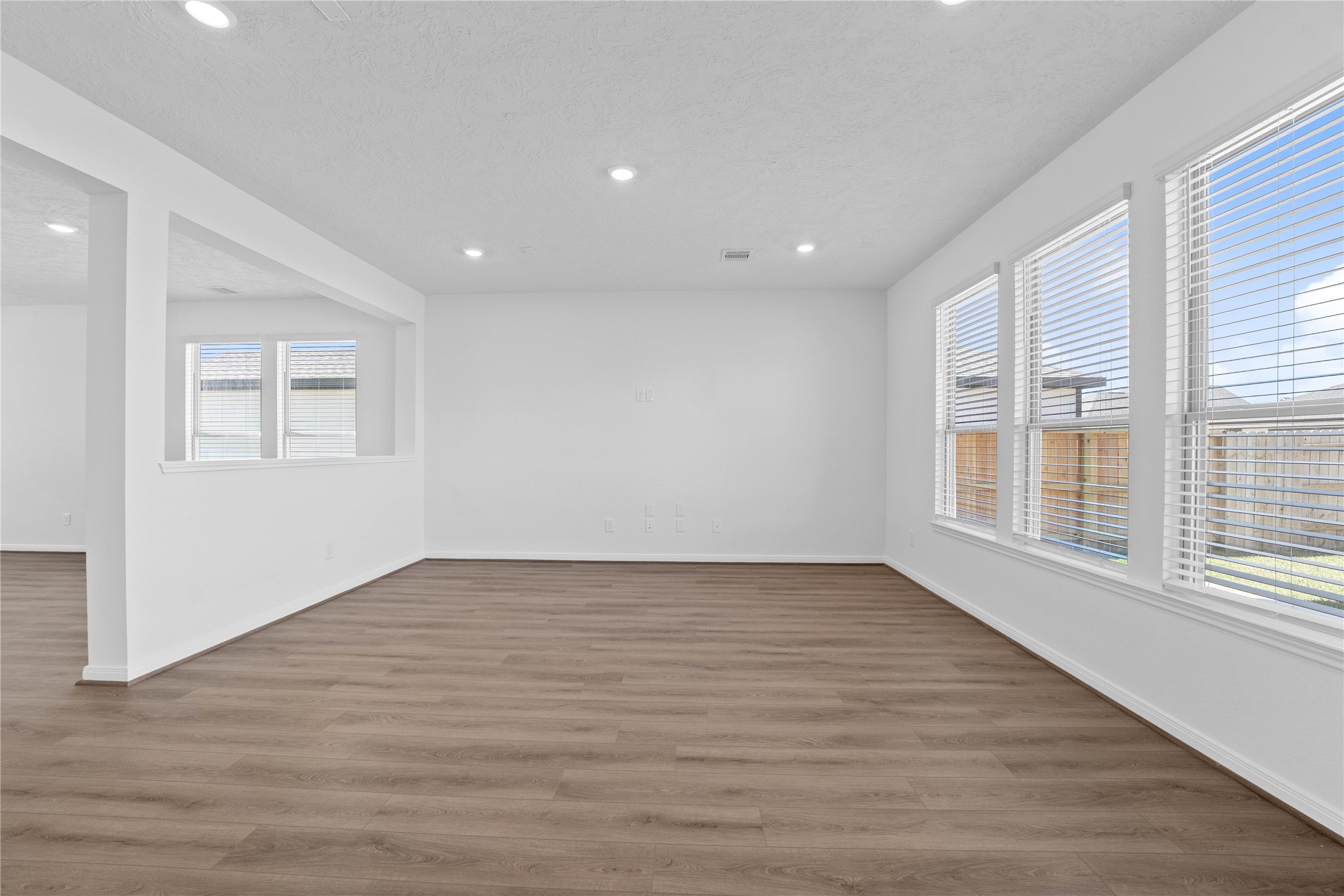 3519 Rocky Aspen Dr Spring Spring, TX 77373 - Photo 7 of 29 Bring family and friends together in this beautiful family room! It features high ceilings, recessed lighting, custom paint, stunning flooring, and large windows that fill the space with natural light all day long.