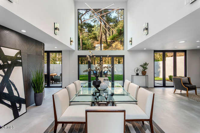 1375 Wierfield Drive Pasadena, CA 91105 - Photo 22 of 68 a dining room with furniture large windows and wooden floor