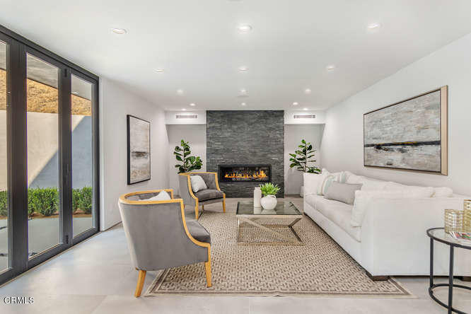 1375 Wierfield Drive Pasadena, CA 91105 - Photo 25 of 68 a living room with furniture a large window and a fireplace