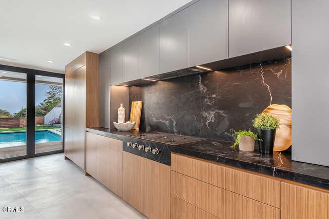 1375 Wierfield Drive Pasadena, CA 91105 - Photo 40 of 68 a kitchen with stainless steel appliances kitchen island granite countertop a refrigerator and a sink