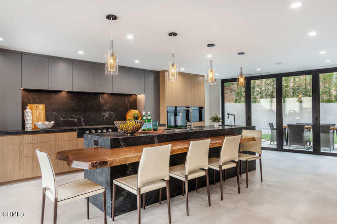 1375 Wierfield Drive Pasadena, CA 91105 - Photo 43 of 68 a dining room with furniture a large window and a projector