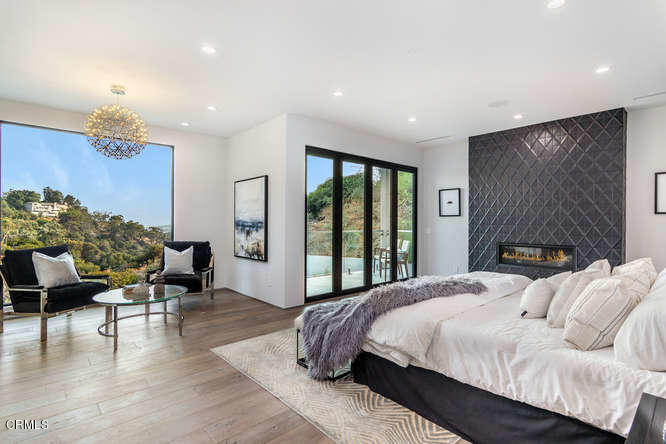 1375 Wierfield Drive Pasadena, CA 91105 - Photo 53 of 68 a bedroom with a bed and large windows