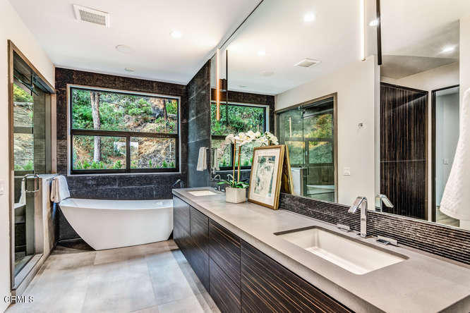 1375 Wierfield Drive Pasadena, CA 91105 - Photo 57 of 68 a bathroom with a large tub a sink and large window