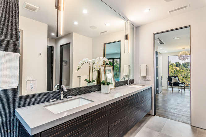 1375 Wierfield Drive Pasadena, CA 91105 - Photo 58 of 68 a bathroom with double vanity sinks and a mirror
