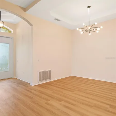 a view of a room with wooden floor and ceiling fan