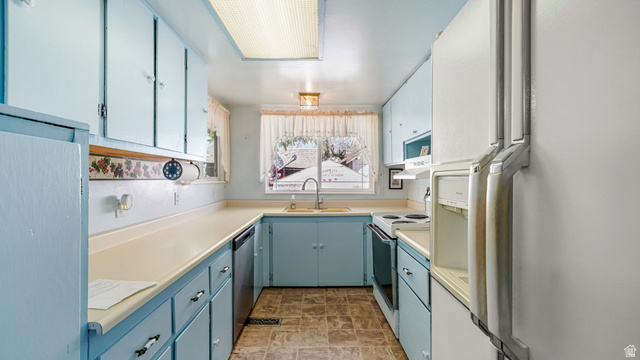 44 Shriver Street Eureka, UT 84628 - Photo 16 of 43 Kitchen featuring light blue cabinetry, light-toned countertops, and a U-shaped configuration