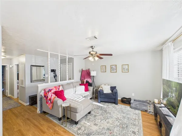 a bedroom with furniture and a flat screen tv