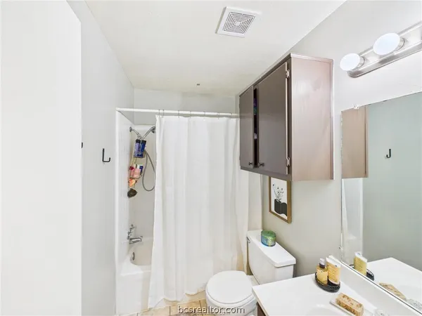 a white toilet sitting next to a bathroom sink