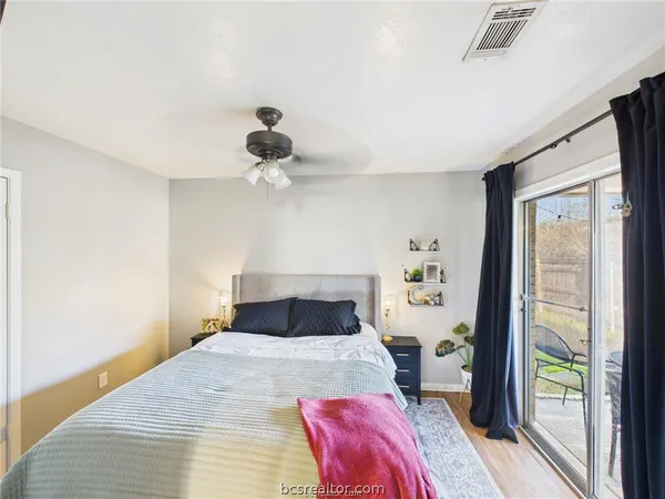 a bedroom with a bed and a large window