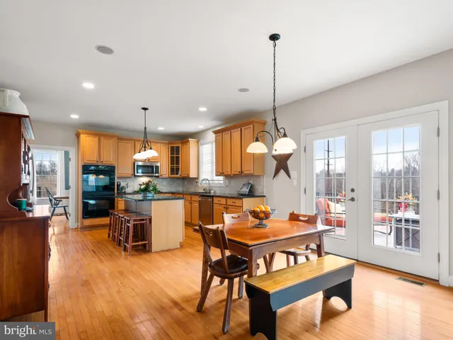 a living room with furniture a flat screen tv and kitchen view