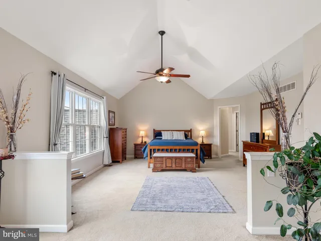 a bathroom with a bathtub a sink a shower and a window
