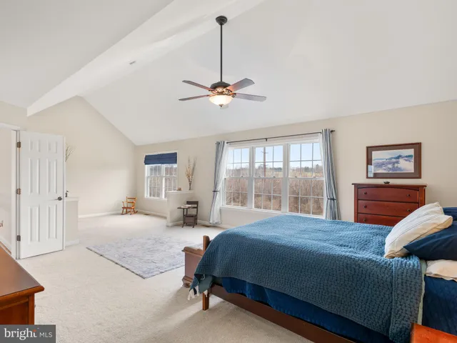 a bedroom with a bed and a desk