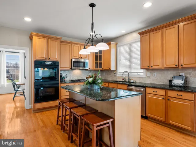 a view of a dining room with furniture a chandelier and wooden floor