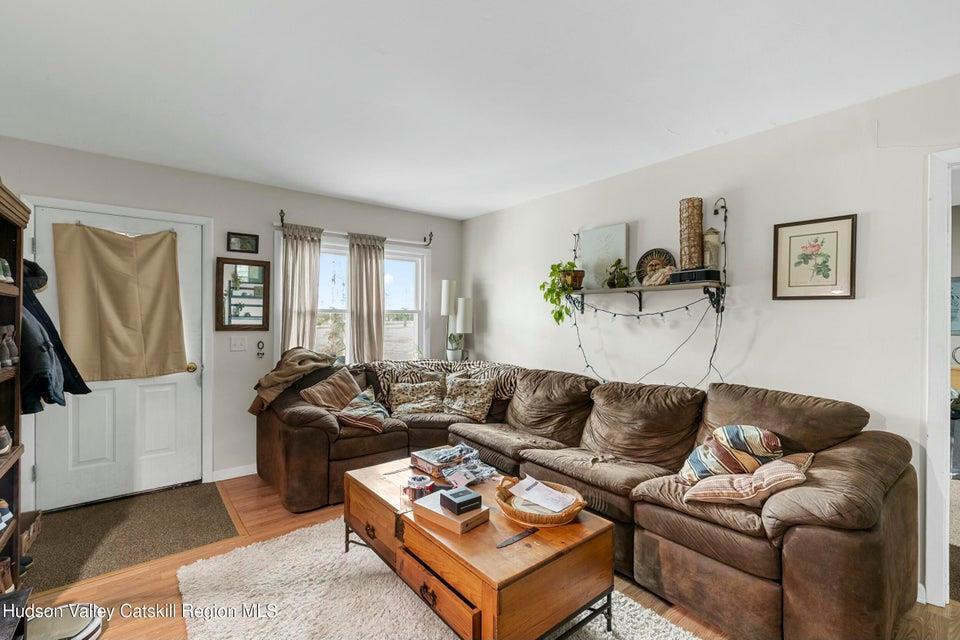 236 State Rte 32 South New Paltz, NY 12561 - Photo 6 of 11 a living room with furniture a couch and a flat screen tv