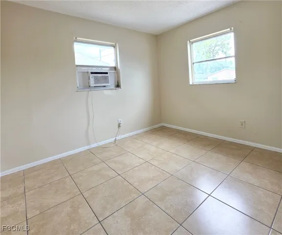 an empty room with a bench and cabinet
