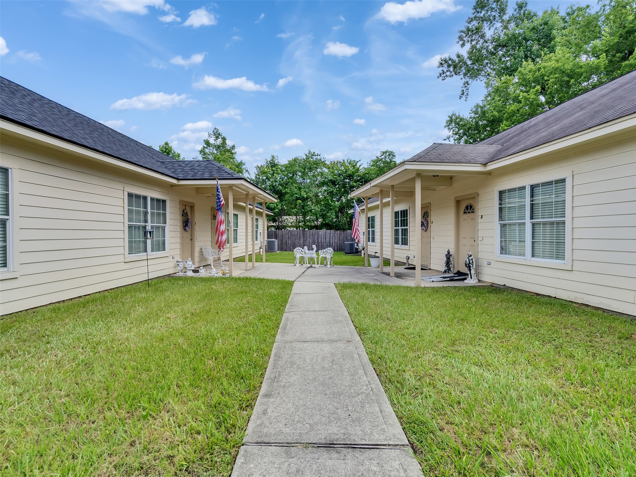 104 Longstreet Road, Unit 2 Willis, TX 77378 - Photo 3 of 26 a view of a house with a yard and potted plants