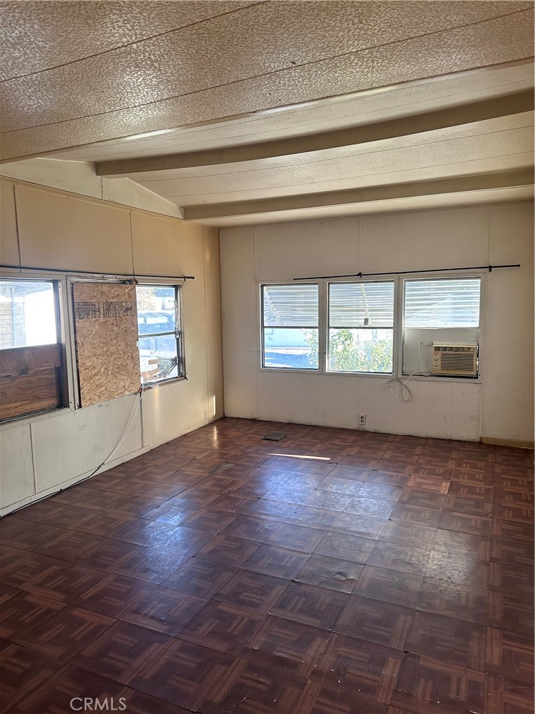 258 West 7th Street, Unit 51 San Jacinto, CA 92583 - Photo 6 of 14 a view of an empty room with wooden floor and a window